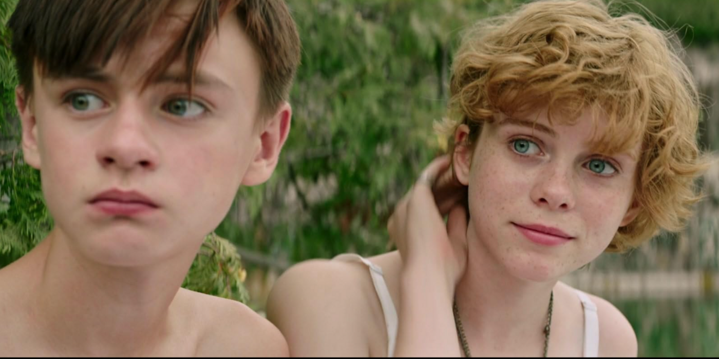 Jaeden Martell and Sophia Lillis looking to their right in It (2017).