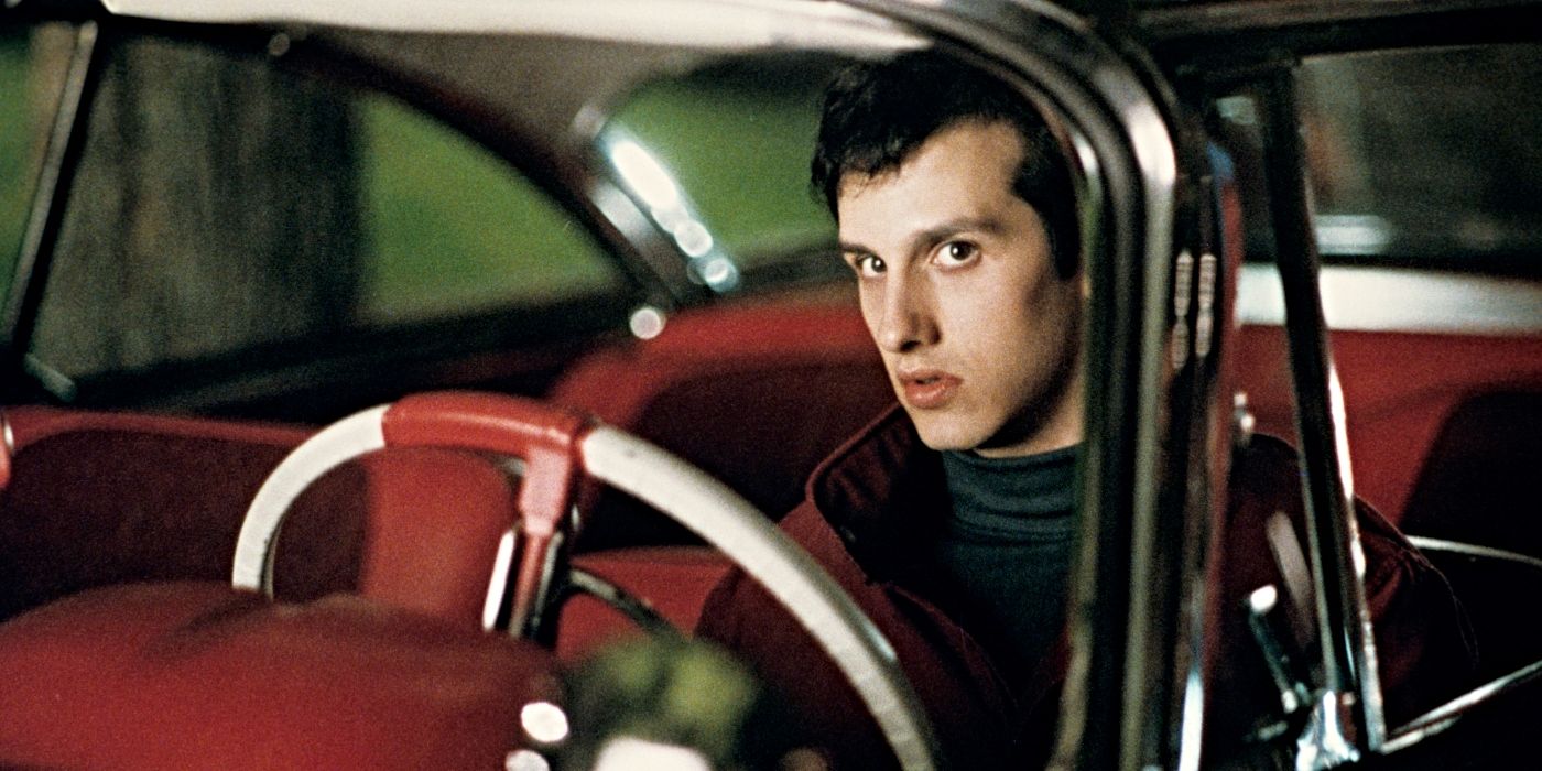 Keith Gordon as Arnie Cunningham, sitting in the car at night and looking serious in Christine