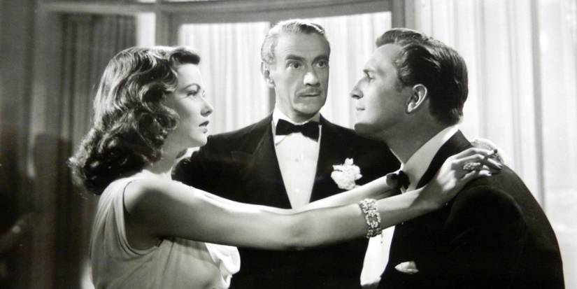 Laura Hunt (Gene Tierney) resting her hands on Shelby Carpenter's (Vincent Price) shoulders while Waldo Lydecker (Clifton Webb) watches in Laura