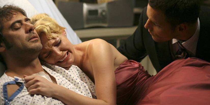 A woman comforts her boyfriend in a hospital bed