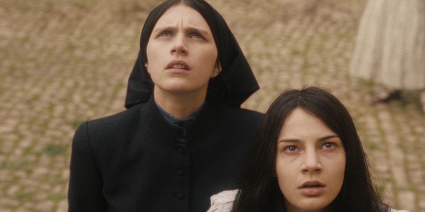 Margaret and Carlita, concerned and looking up at something in The First Omen