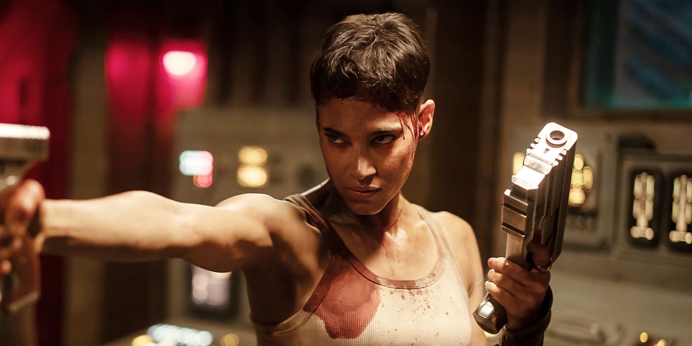 Kora holding two guns in Rebel Moon - Part Two: The Scargiver. 