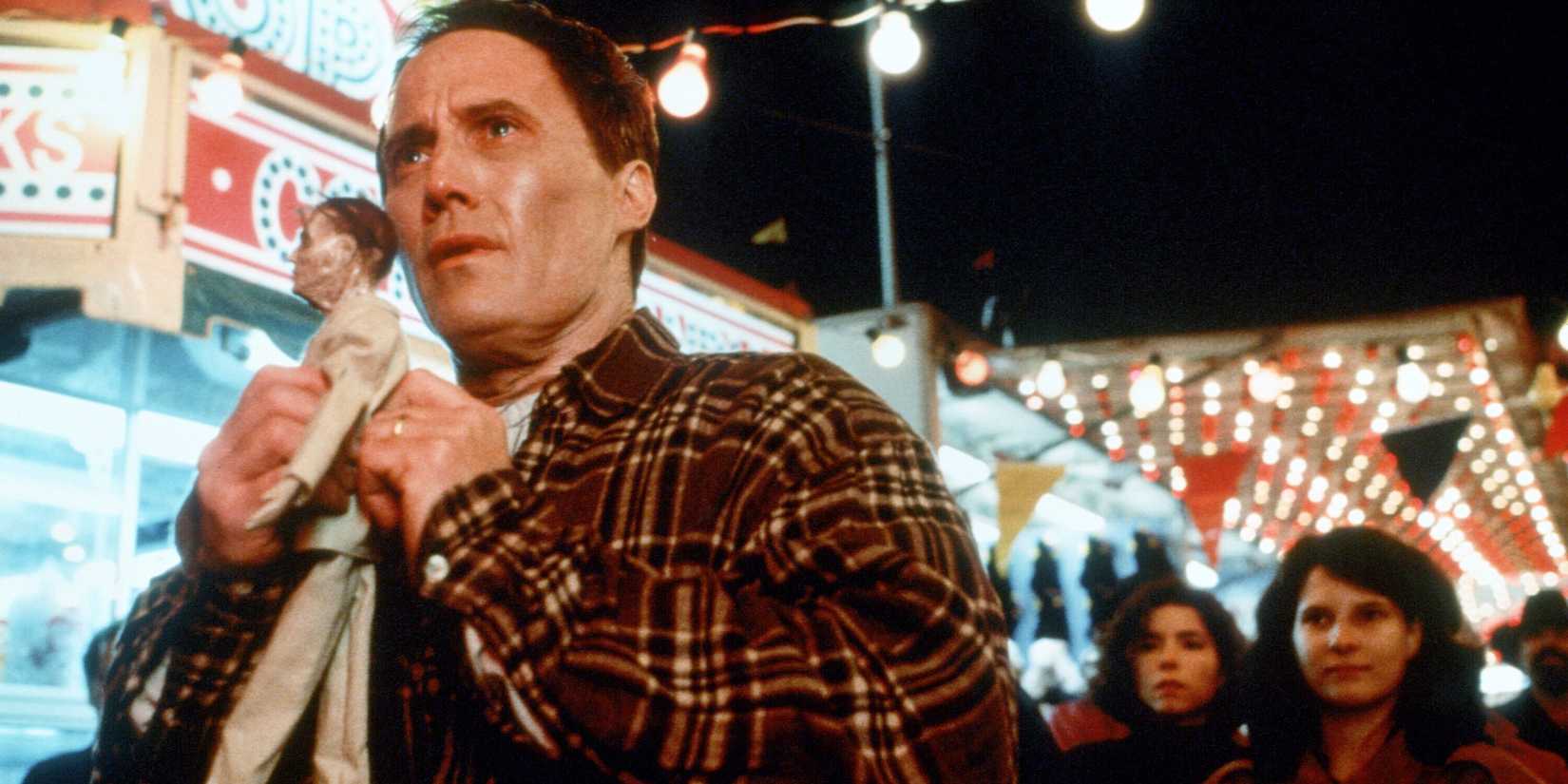 Billy Halleck, played by actor Robert John Burke, holds a Voodoo doll of himself at a local carnival in Thinner.