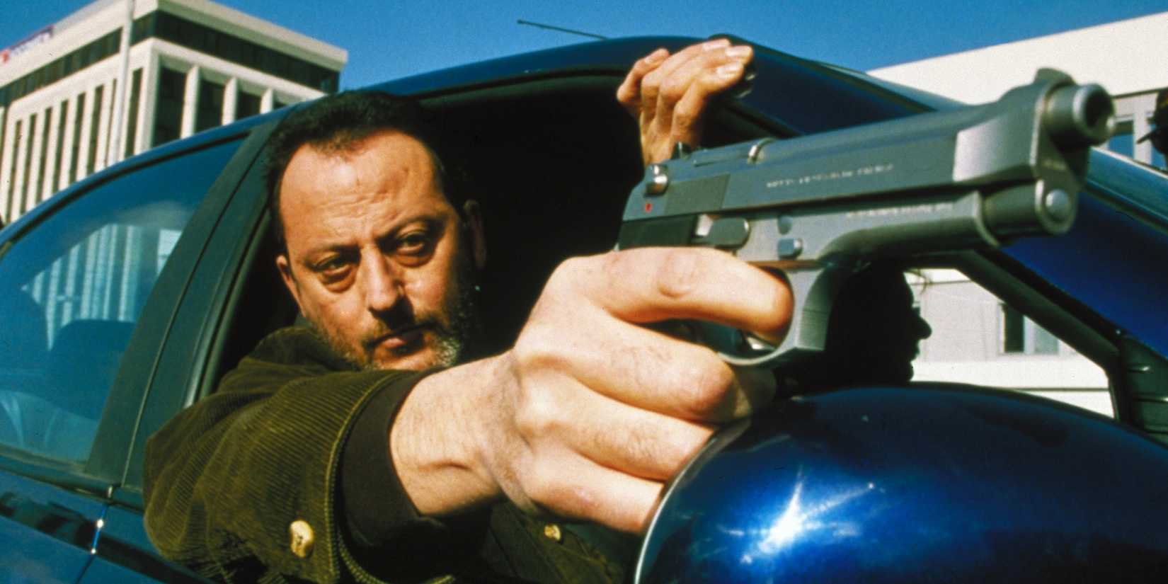Close up of Vincent (Jean Reno) aiming a pistol out of a car window in 'Ronin'