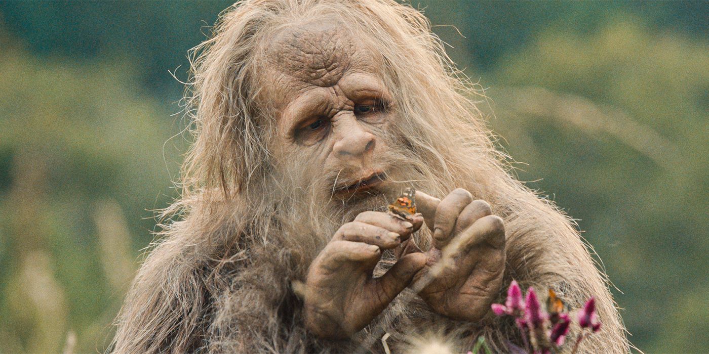 Jesse Eisenberg holding a butterfly in Sasquatch Sunset.