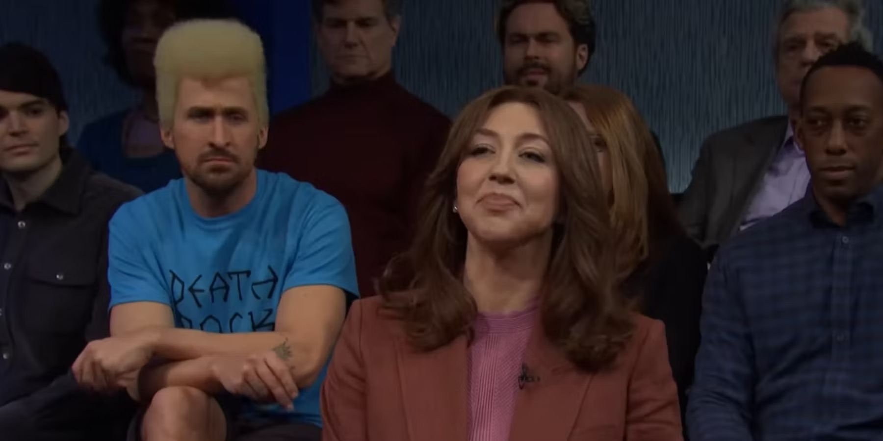 Heidi Gardner tries not to laugh as Ryan Gosling is behind her dressed as Beavis on Saturday Night Live.