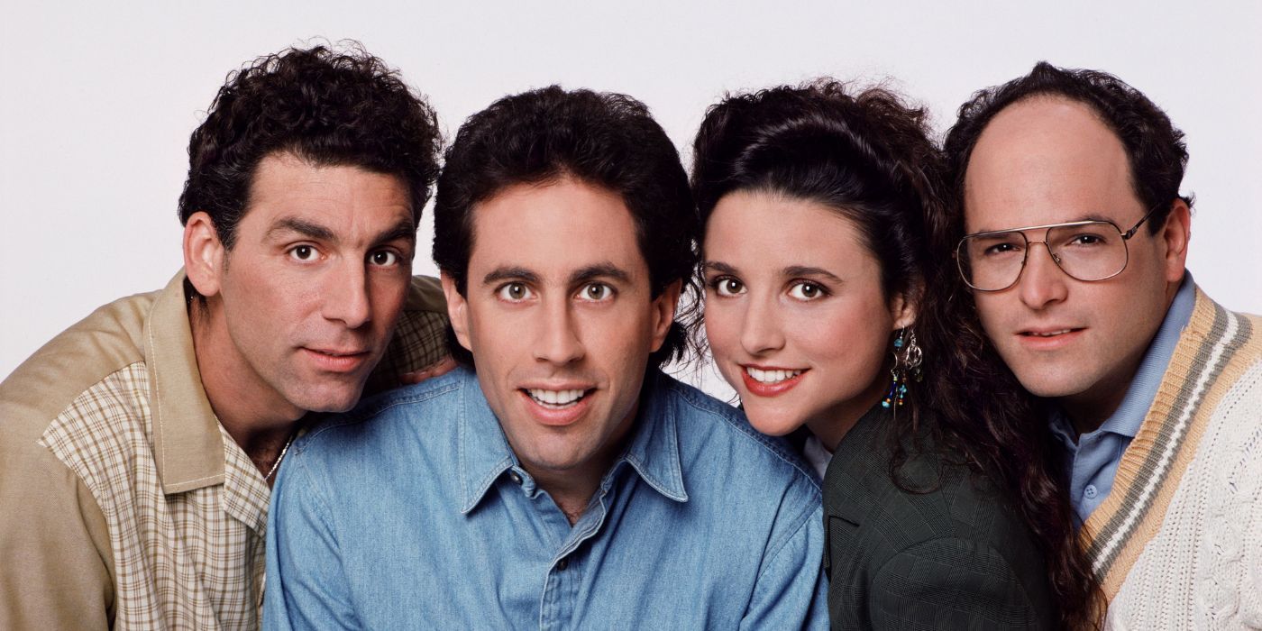  Kramer, Seinfeld, Elaine, & George, huddled against a white backdrop