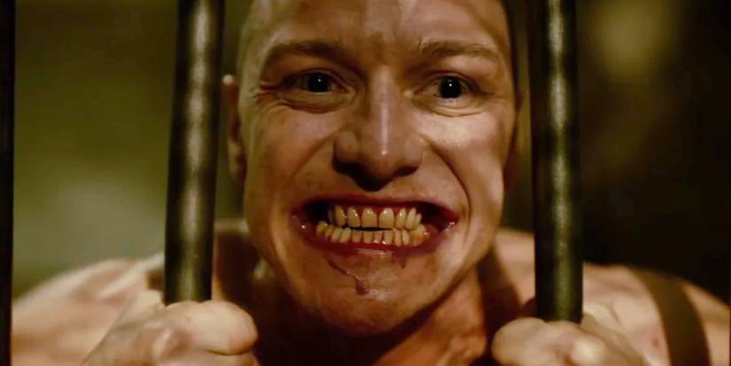 James McAvoy as the Horde aka Kevin Wendell Crumb smiling while prying bars apart in Split