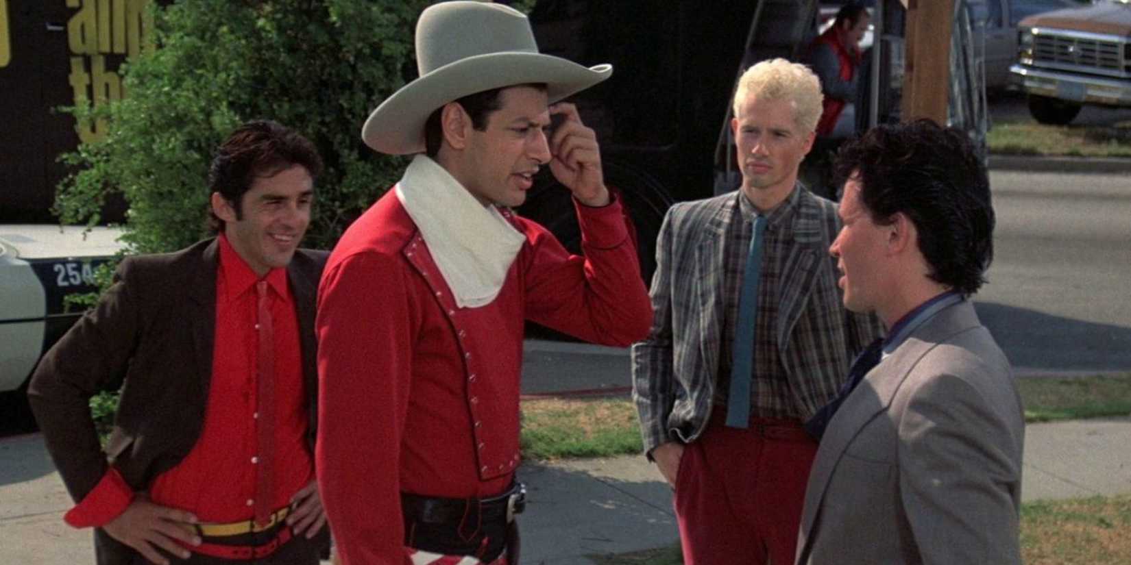 Jeff Goldblum wears a cowboy outfit and hat and talks to others in The Adventures of Buckaroo Banzai.