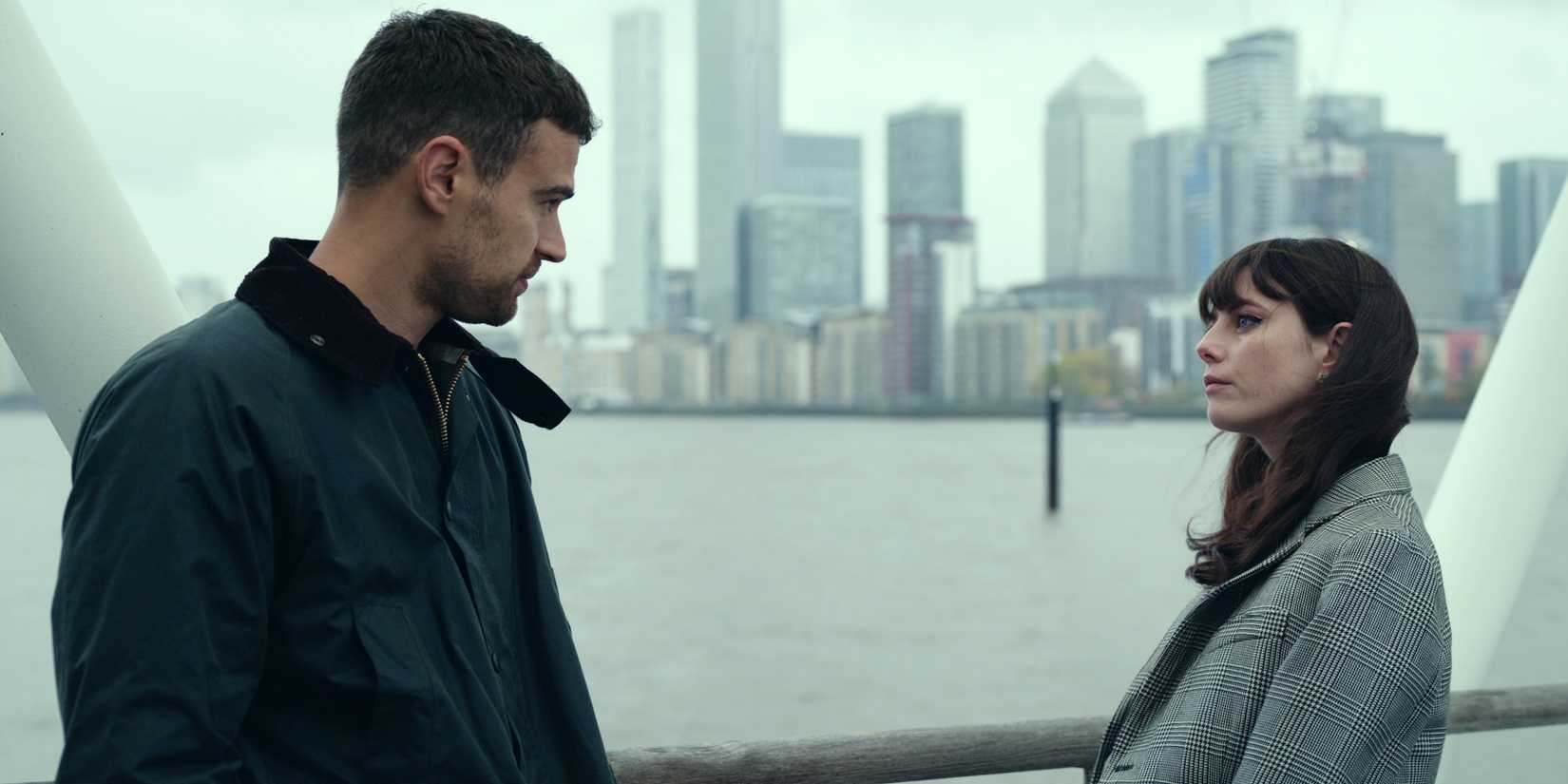 Kaya Scodelario as Susie standing across from Theo James as Eddie on a bridge