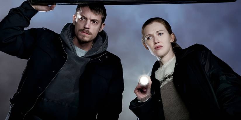 Sarah Linden with a flashlight and Stephen Holder at her side in The Killing Season 1.