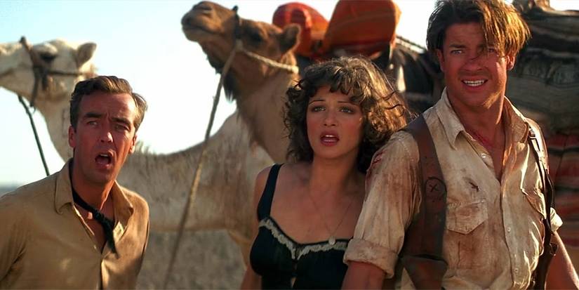 Jonathan Carnahan (John Hannah), Evie Carnahan (Rachel Weisz), and Rick O'Connell (Brendan Fraser) looking offscreen to the left with shoked expressions in The Mummy