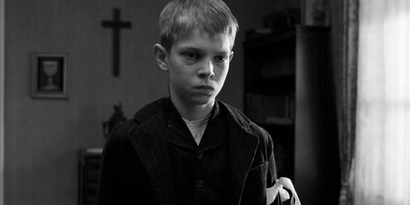 Martin (Leonard Proxauf) is on the verge of tears as his father berates him in The White Ribbon