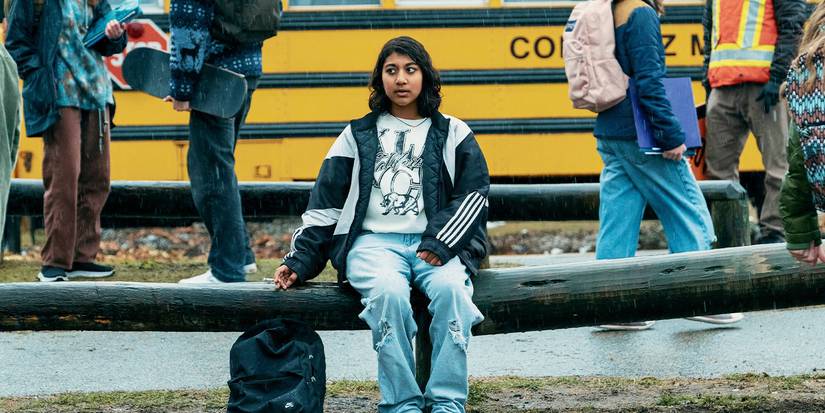 Vritika Gupta as Reena Virk sitting outside her school in Under the Bridge.
