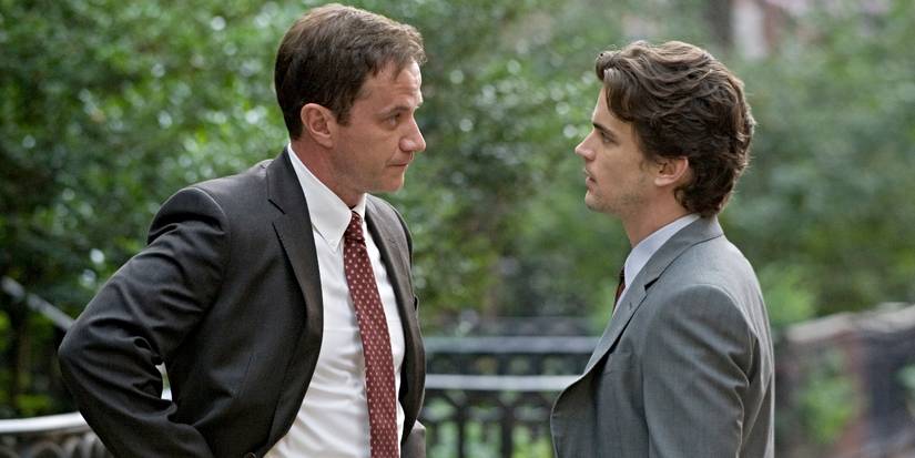 Matt Bomer and Tim DeKay as Neal Caffrey and Peter Burke, talking outside in White Collar