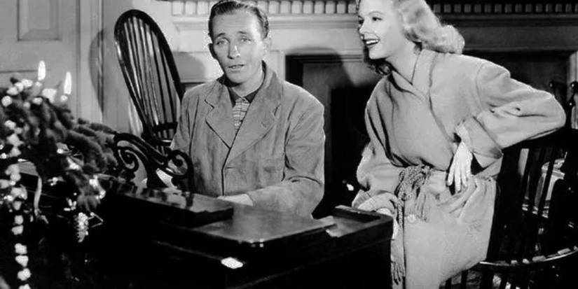 Linda and Jim, played by actors Marjorie Reynolds and Bing Crosby, sit at a piano and sing together in Holiday Inn.
