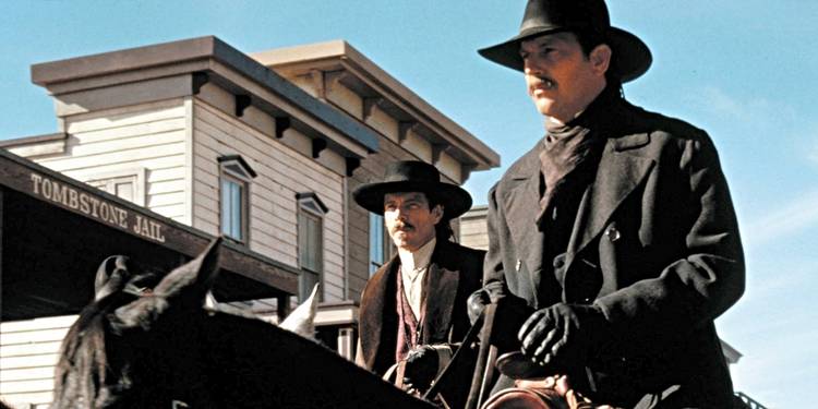 Kevin Costner and Dennis Quaid as Wyatt Earp and Doc Holliday riding horses in 'Wyatt Earp' (1994)