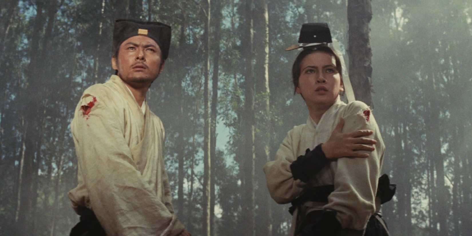 Ying Bai and Feng Hsu with wounded arms in a forest in A Touch of Zen (1971).