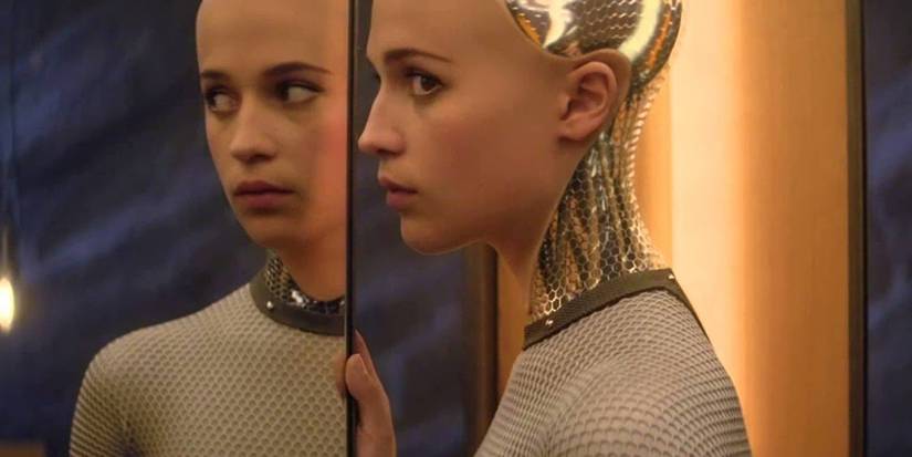 Ava in front of a mirror looking to her left in Ex-Machina.