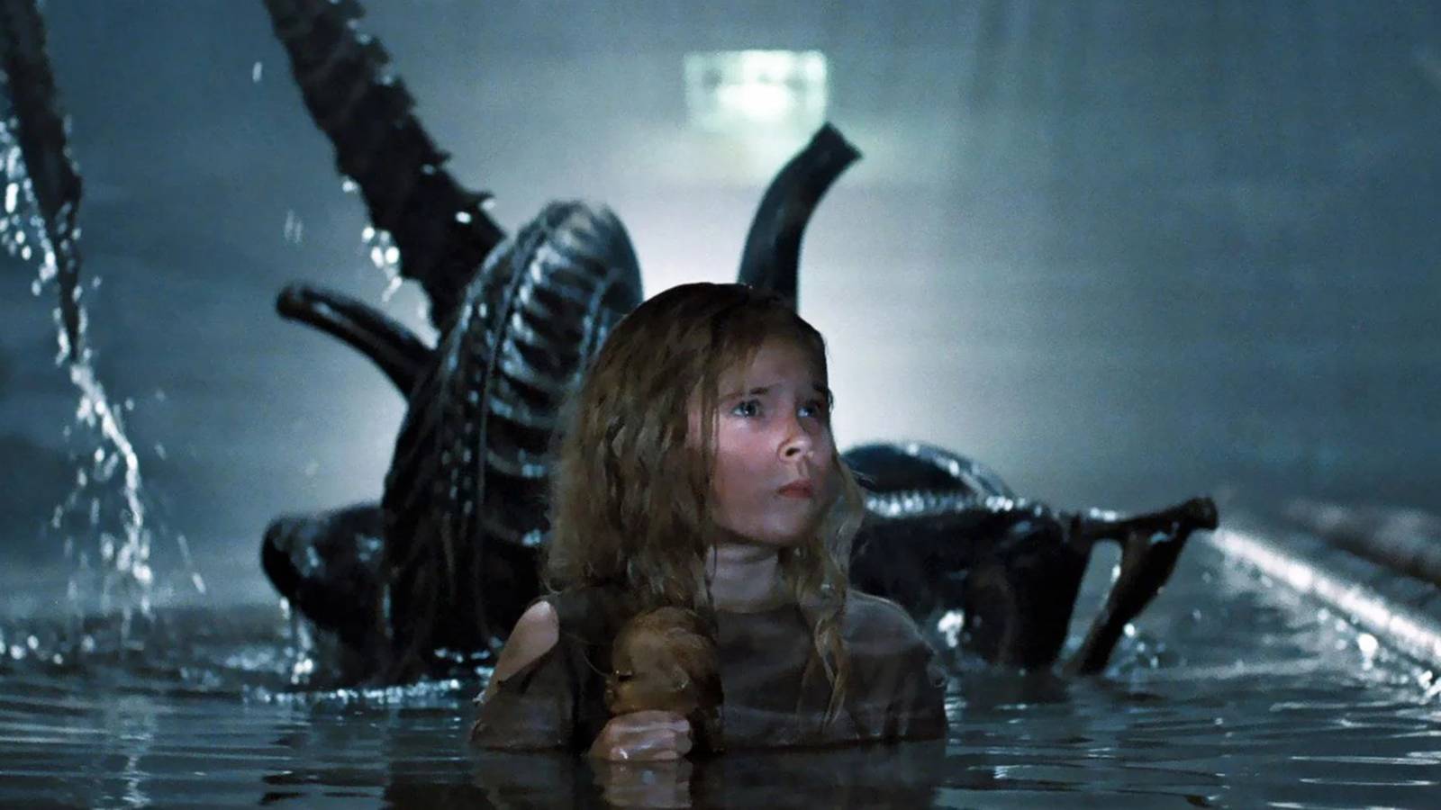 Newt in a pool with the xenomorph behind her in Aliens