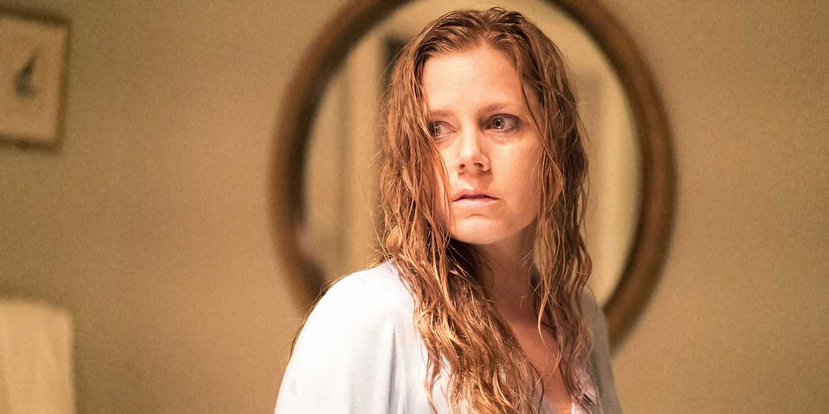 Amy Adams as Camille Preaker looking at something intently in Sharp Objects.