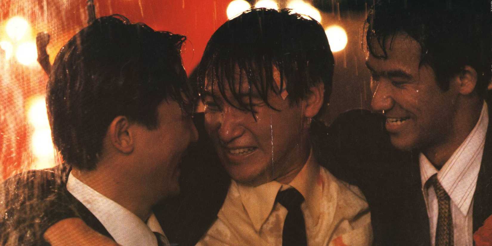 The cast of Bullet in the Head all smiling and holding each other.