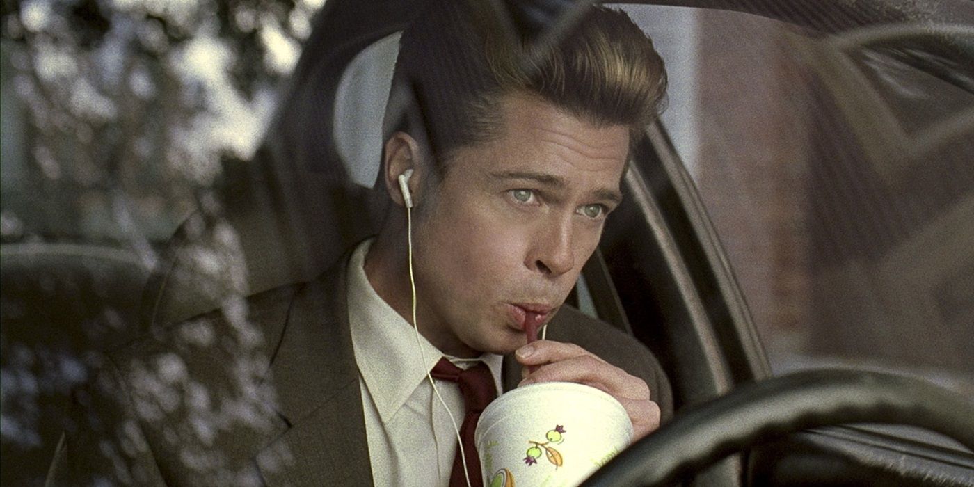 Brad Pitt as Chad Feldheimer drinking a milkshake in his car in Burn After Reading Movie.