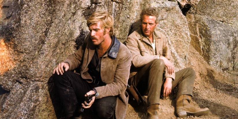 Butch Cassidy (Paul Newman) and the Sundance Kid (Robert Redford) sitting on a cave in 'Butch Cassidy and the Sundance Kid'