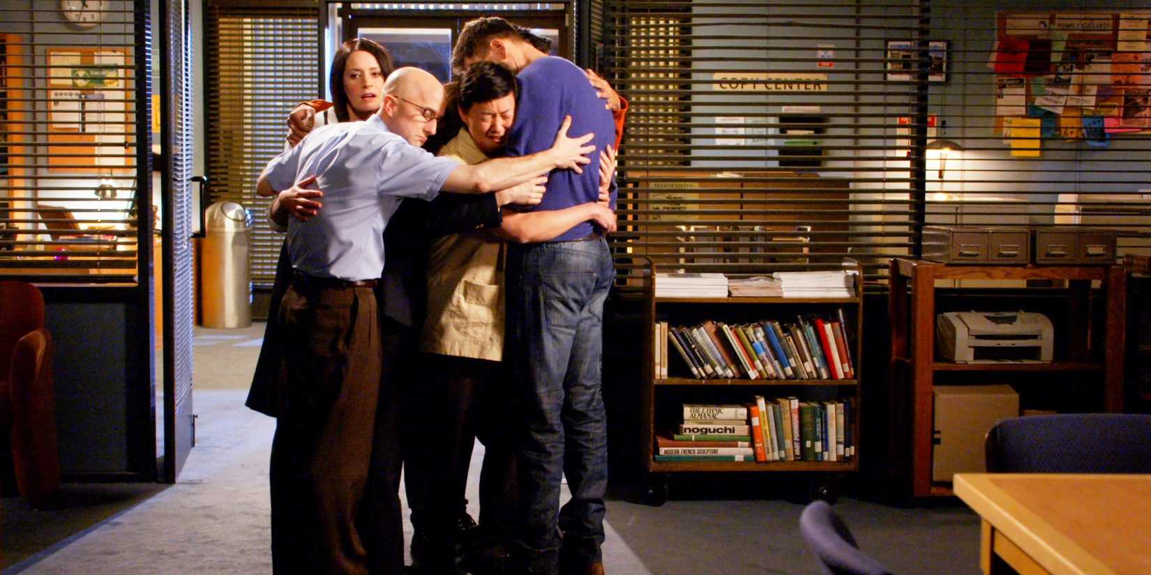 The Save Greendale Committee group hugging in the study room in the series finale of Community.