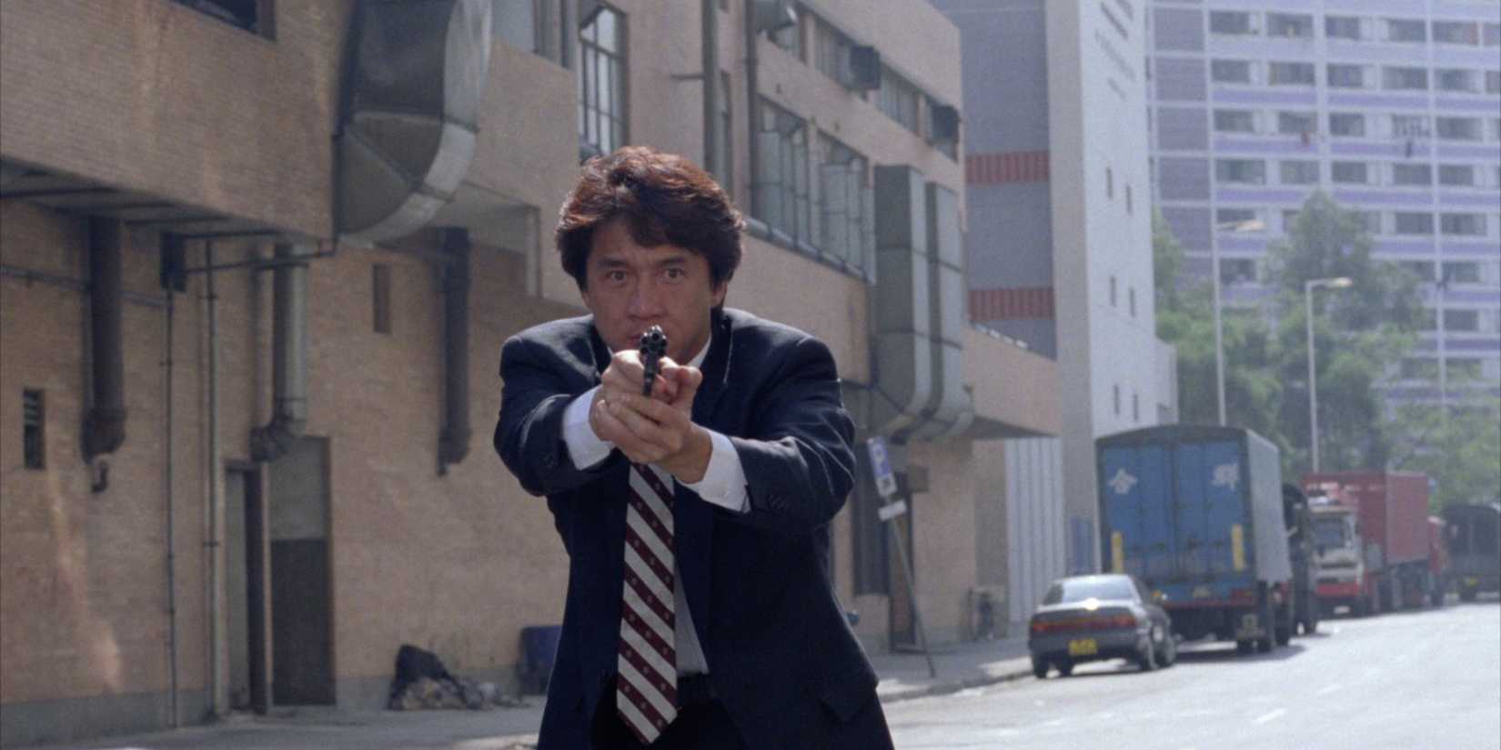 Jackie Chan aiming a gun in Crime Story