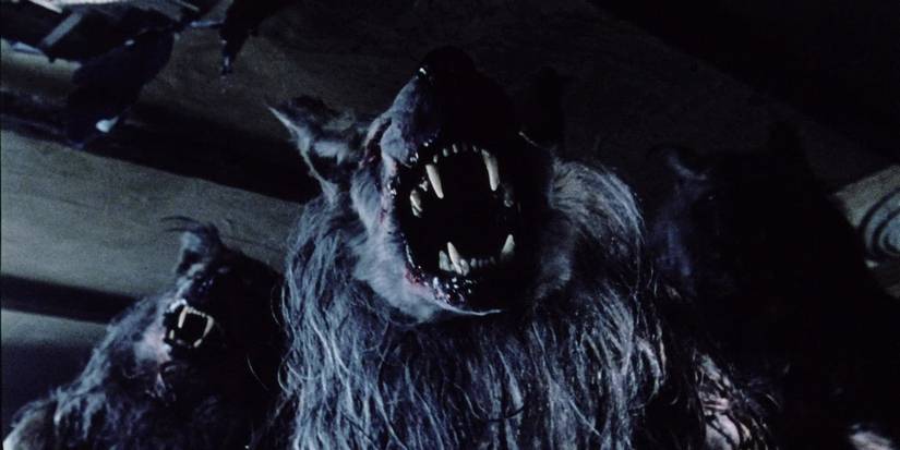 The shadowy figures of three werewolves baring their teeth in Dog Soldiers.