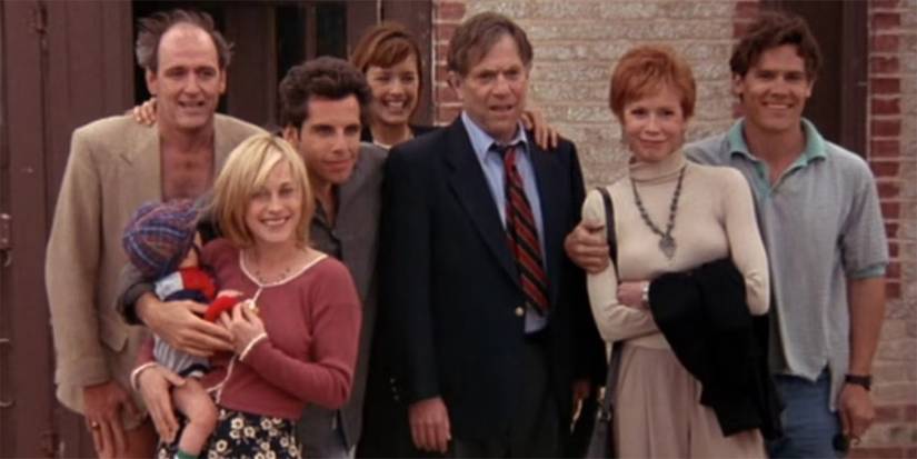 The cast of Flirting with Disaster pose for a family photo outside a house