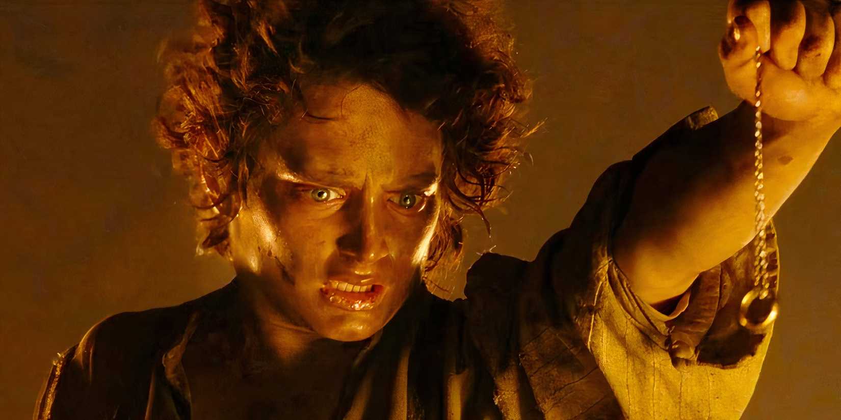 A still from The Return of the King of Frodo, played by actor Elijah Wood, holding the One Ring over the fires of Mount Doom. 