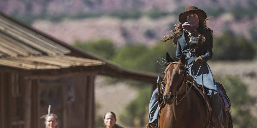 Michelle Dockery as Alice Fletcher, wearing a face cover and riding a brown horse in Godless