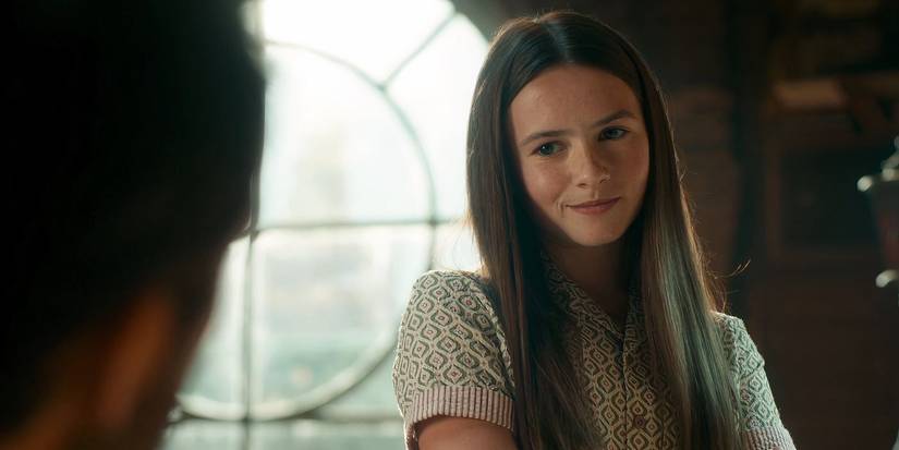 Cailey Fleming as Bea, smirking in front of a circular window.