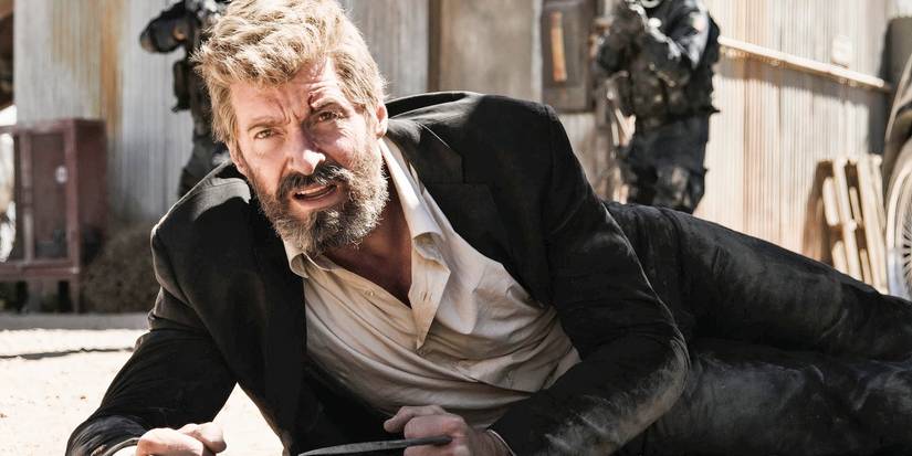 Hugh Jackman as Logan on the ground and dusty in Logan.