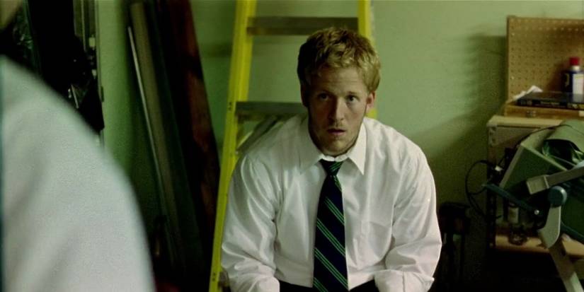 David Sullivan as Abe sitting on a ladder in Primer