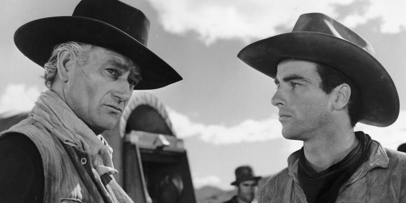 Montgomery Clift as Matthew looking at John Wayne as Thomas, who is looking to his right in Red River.