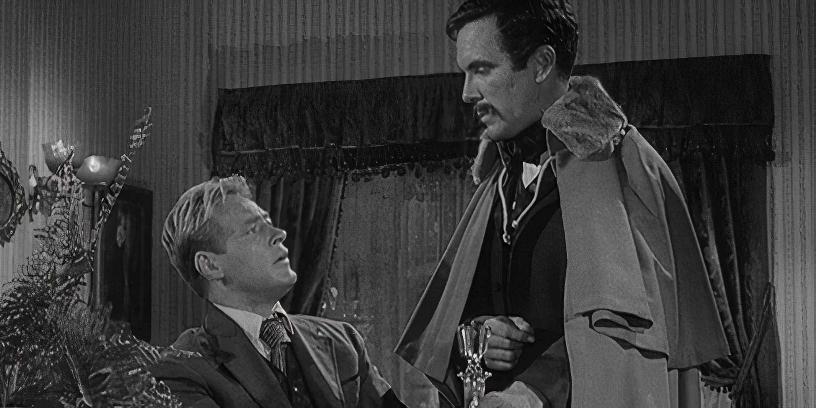 Russell Johnson sitting looking up at John Lasell who is standing in front of him in The Twilight Zone