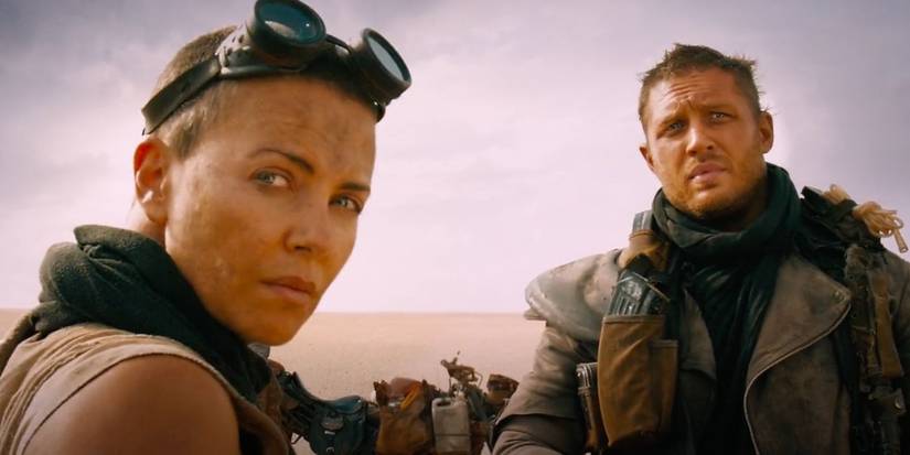 Furiosa (Charlize Theron) and Max (Tom Hardy) looking to the distance in Mad Max: Fury Road (2015).
