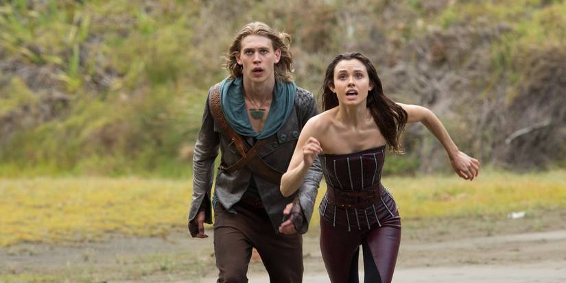 Two characters running toward the camera in an open field in the Shannara Chronicles.