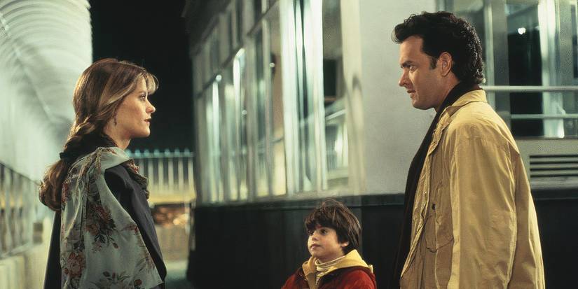 Meg Ryan and Tom Hanks look at one another, a young boy beside Hanks in the movie Sleepless in Seattle.
