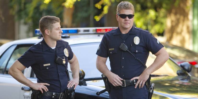 Ben McKenzie and Michael Cudlitz in police uniforms in front of a cop car in 'Southland.'