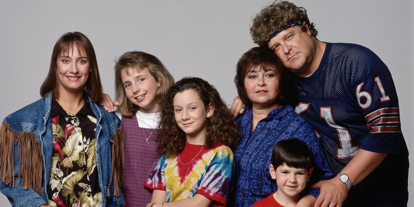 The Conners posing together for a promotional photo for Roseanne.