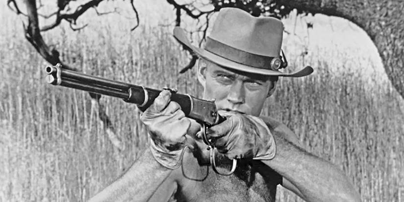 Chuck Connors as Lucas McCain, shirtless and pointing a rifle in The Rifleman