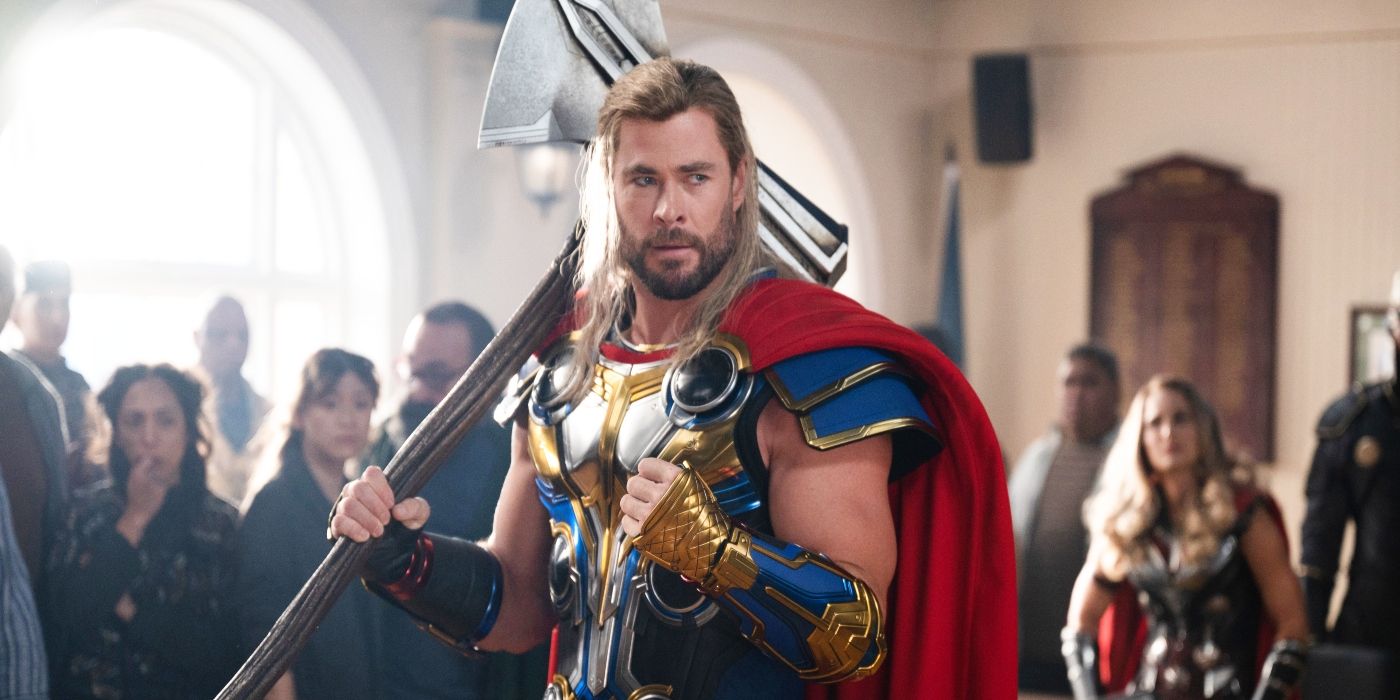 Thor in Thor: Love and Thunder, wielding Stormbreaker and looking into the camera