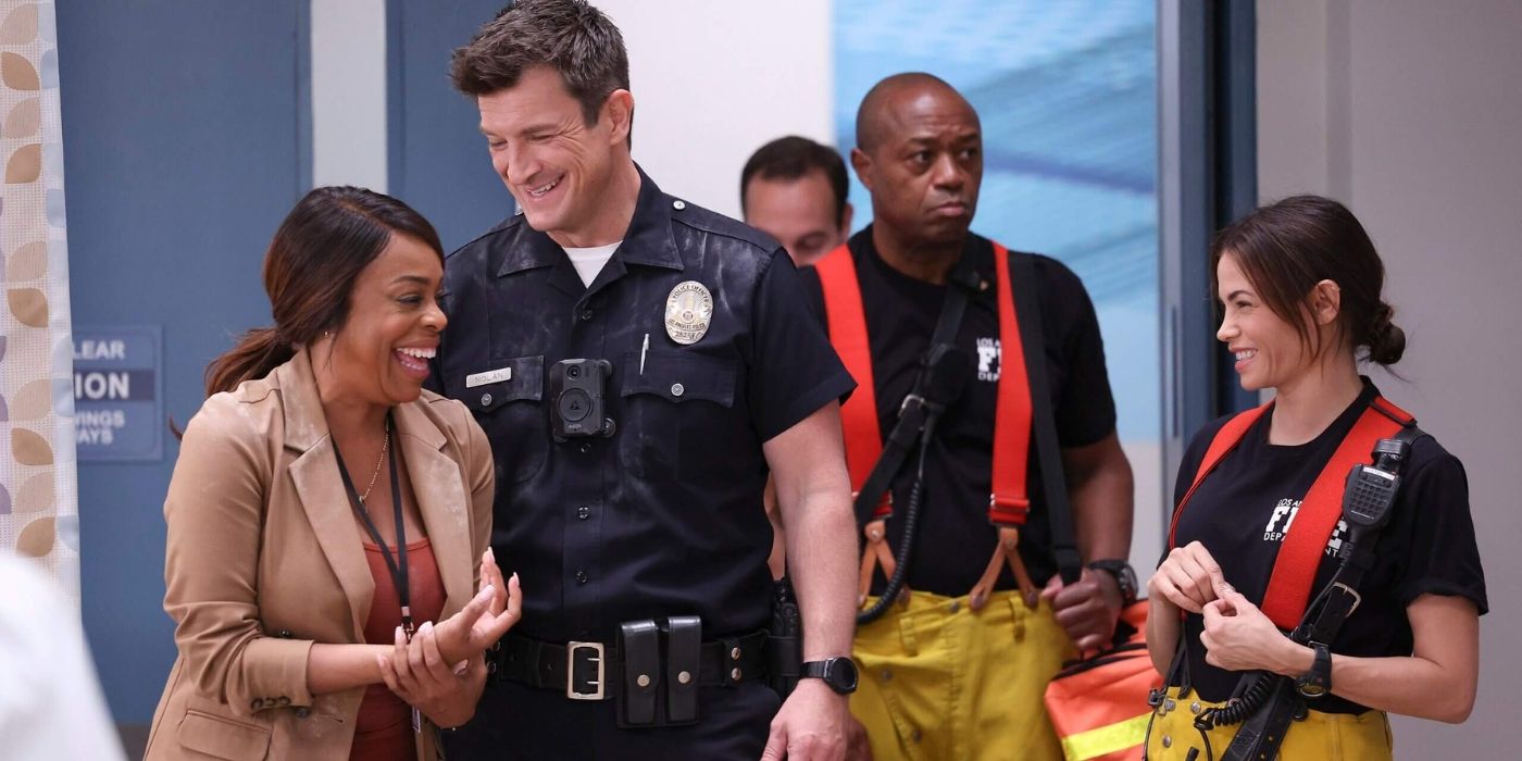 Nathan Fillion and Niecy Nash-Betts laugh together in the office in The Rookie