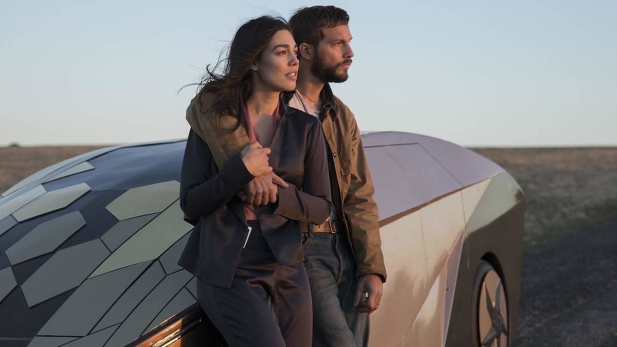 Grey Trace and Asha Trace leaning on a self-driving car, arms around each other, in Upgrade