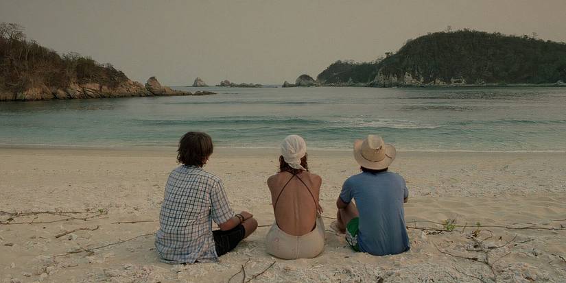 Tenoch, Julio, and Luisa all sitting on the beach together in 'Y Tu Mama Tambien' (2001).