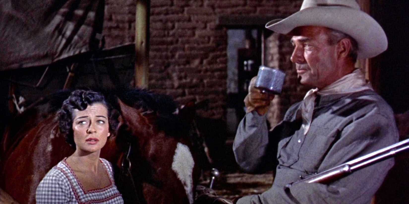 Gail Russell as Annie Greer and Randolph Scott as Ben Stride standing beside a horse in Seven Men From Now 
